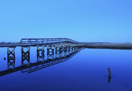 Bridge reflecting in water, blue image