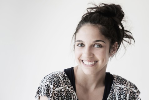 Portrait of teenage girl (14-15) smiling in studio.