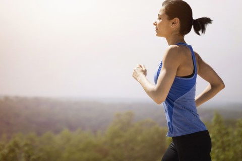 Young woman running outdoors.
