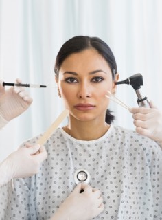 Patient being examined using medical instruments.