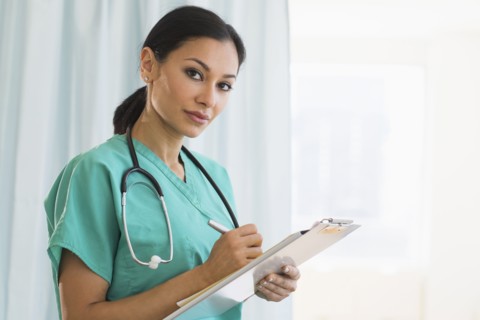 Female doctor making notes.