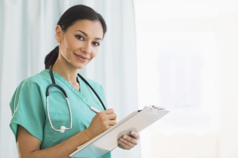 Female doctor making notes.