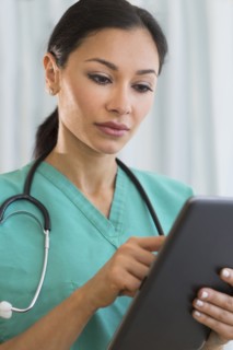 Female doctor using digital tablet.