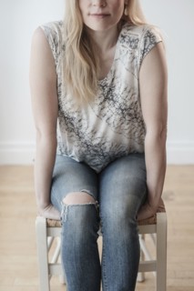 Low-section of woman wearing torn jeans.