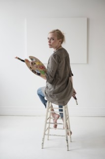 Female artist painting in studio.