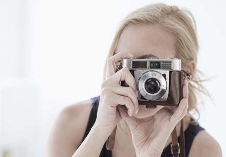 Woman taking photo with digital camera.
