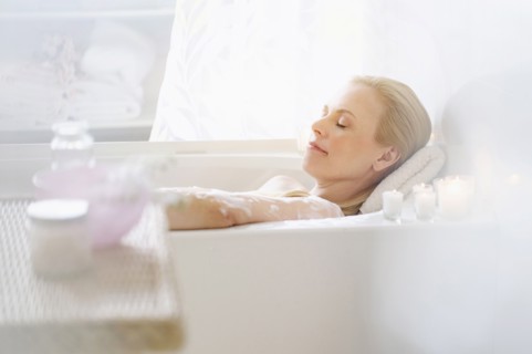 Woman relaxing in bath.
