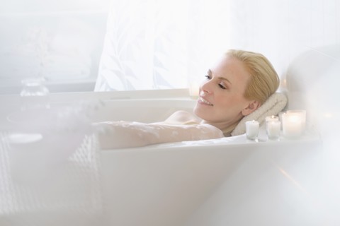 Woman relaxing in bath.