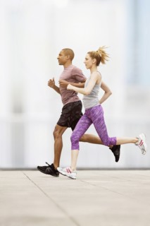 Mid adult couple running.