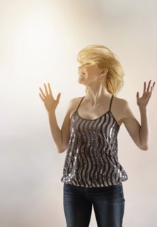 Happy woman dancing in studio.