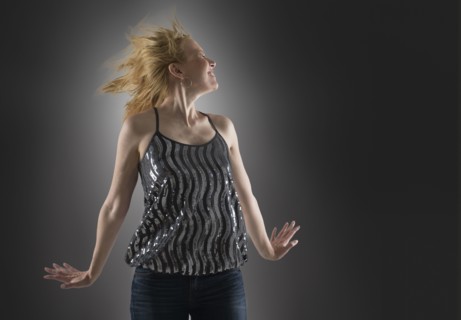 Happy woman dancing in studio.