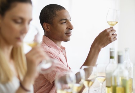 Man and woman tasting white wine.