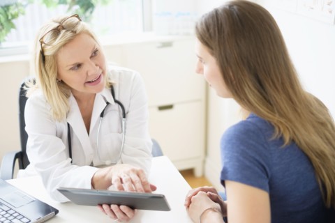 Doctor talking to patient in office.