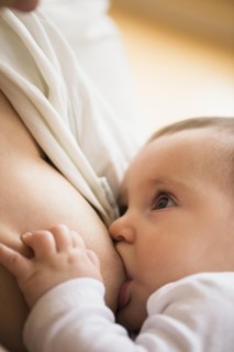 Mother breastfeeding her daughter (2-5 months)