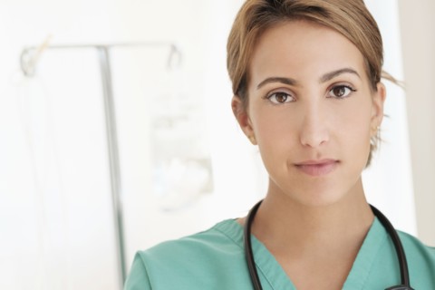 Young female doctor in hospital corridor.
