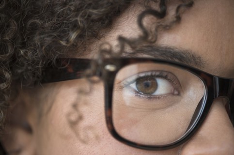 Close up of young woman in nerdy glasses.