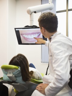 Dentist and patient looking at screen