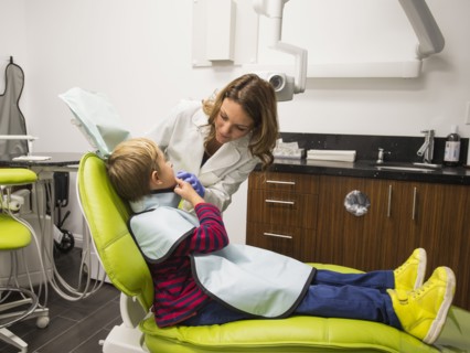 Dentist and patient (8-9) in dentist's office
