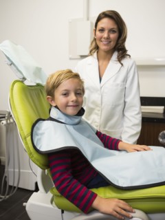 Dentist and patient (8-9) in dentist's office