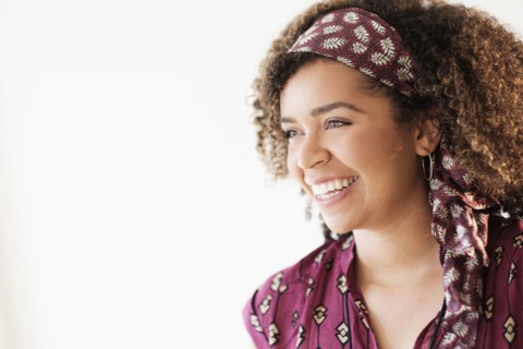 Portrait of smiling woman with curly hair.