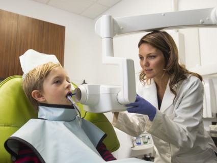 Dentist and patient (8-9) in dentist's office