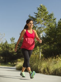 Pregnant woman walking outdoors