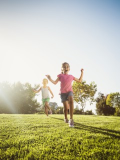 Siblings (2-3, 6-7, 8-9) playing in park