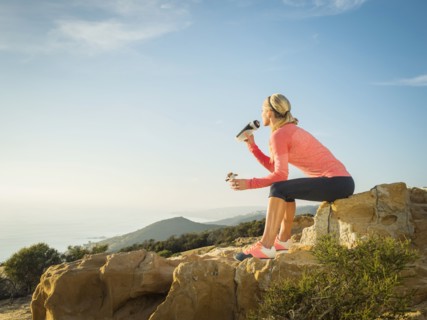Woman in sportswear drinking water