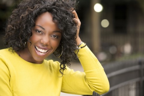 Smiling woman with hand in hair