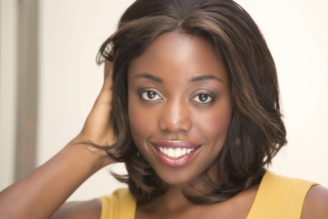 Smiling woman with hand in hair