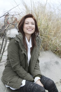 Portrait of woman in parka on winter beach