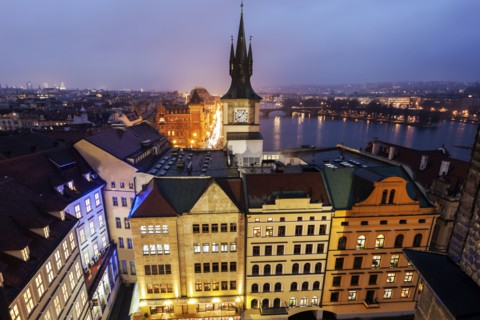 Old town tower by Vltava River at sunset