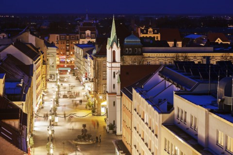 Illuminated old town street with tower of Schlosskirche