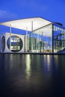 Riverfront parliament office building illuminated at dusk