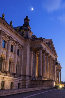 Moon over Bundestag building at dusk