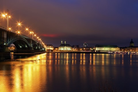 Illuminated Theodor Heuss Bridge and waterfront skyline