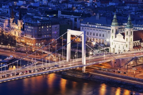 Riverfront cityscape with Elisabeth Bridge and Franciscan Church
