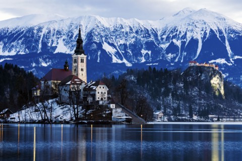 View of Church of the Assumption with lake and mountain