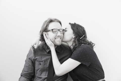 Woman kissing smiling man