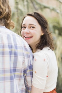 Young smiling woman next to boyfriend