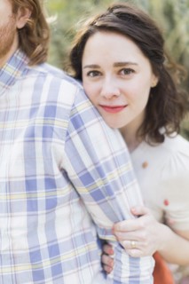 Young smiling woman next to boyfriend