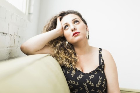 Woman looking up and daydreaming