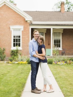 Young couple standing on footpath in front of house