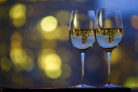 Two wineglasses with white wine. USA, New York, New York City.