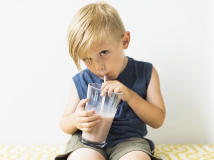 Young boy (2-3) drinking milkshake