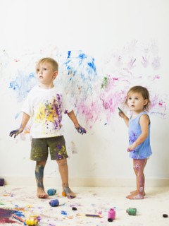 Children (2-3) painting on wall