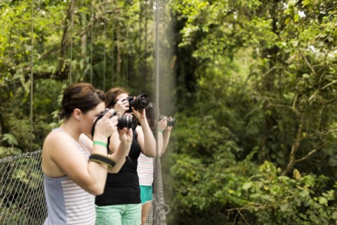 Young women photographing in forest