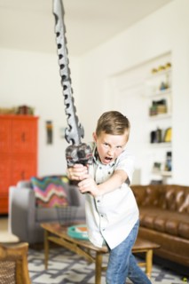 Boy (6-7) playing with sword