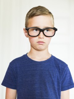 Portrait of boy (6-7) wearing eyeglasses