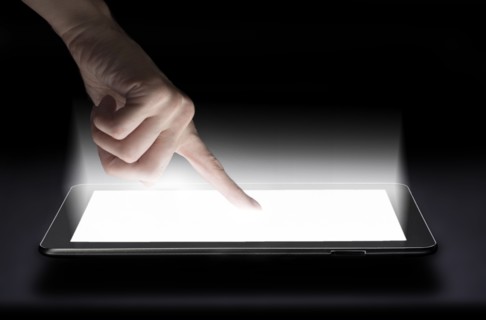 Woman touching digital tablet in studio.